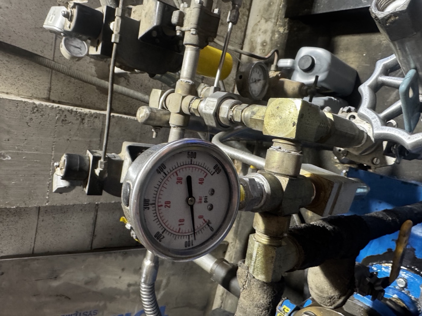 CO2 pressure gauge on the Quality Beverage transfer manifold in Fresno, needle sitting low on the dial